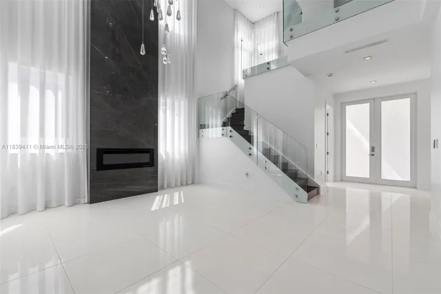 a kitchen with stainless steel appliances kitchen island granite countertop a refrigerator and a stove top oven