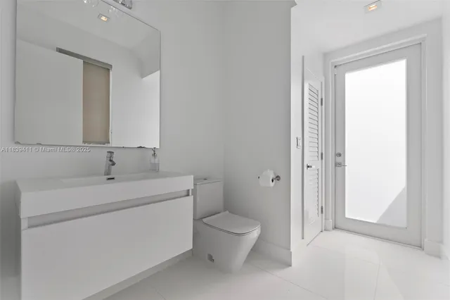 a view of an empty room with wooden floor and window