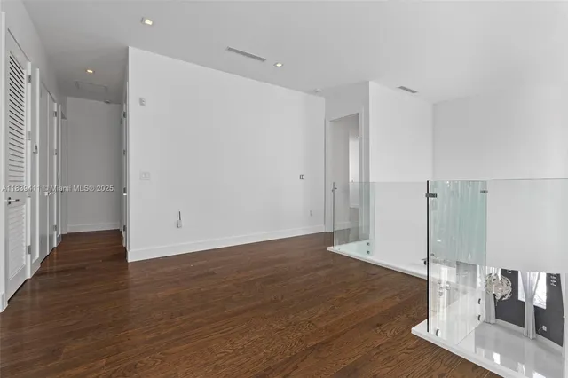 a bathroom with a tub a sink and a large mirror
