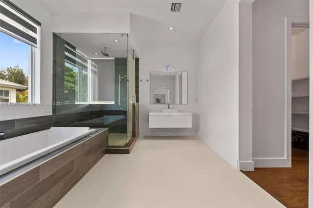 a bathroom with a toilet sink and a mirror