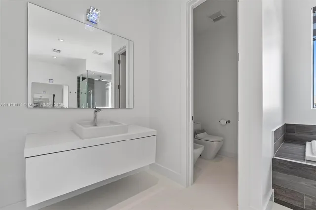 a bathroom that has a toilet and a shower