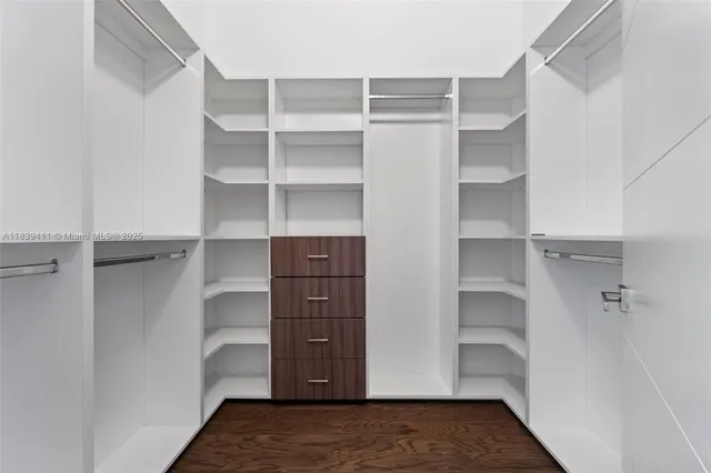 an empty room with wooden floor and a window