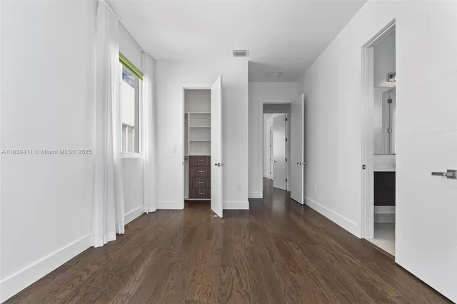 a kitchen with stainless steel appliances granite countertop a stove a sink and a white wooden cabinets