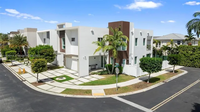 a view of a lobby with a potted plant and a table and chairs