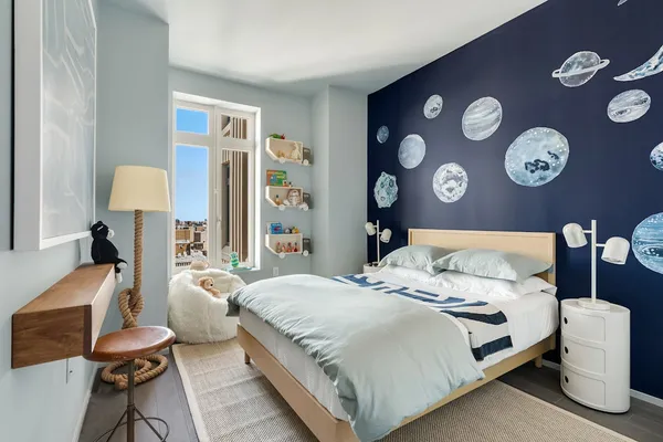 a bedroom with a large bed and a lamp