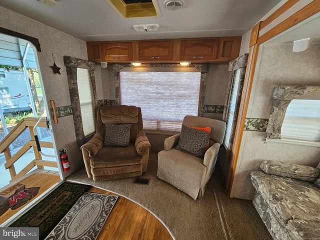 a large bed sitting in a bedroom next to a window