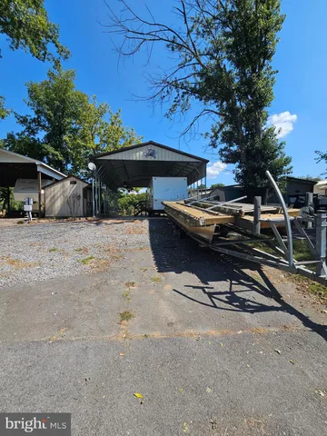 a view of backyard with a table and chairs under an umbrella