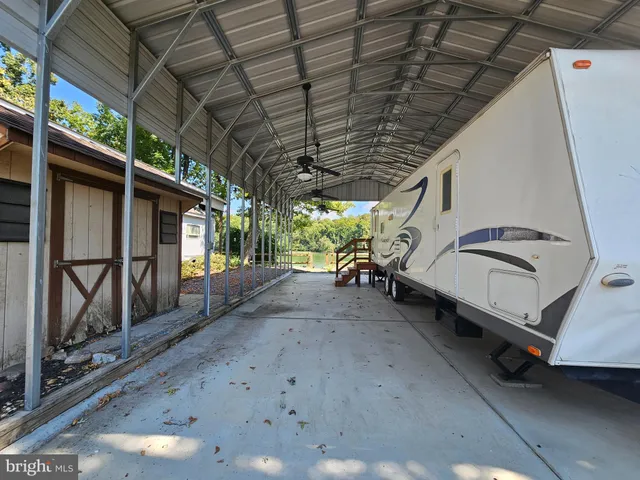 a view of a porch with furniture and a yard