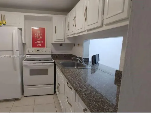 a kitchen with appliances cabinets and a sink