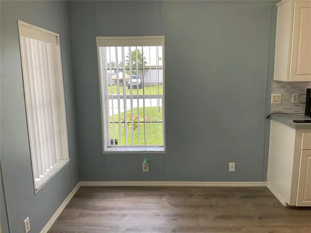 a living room with furniture large window and flat screen tv