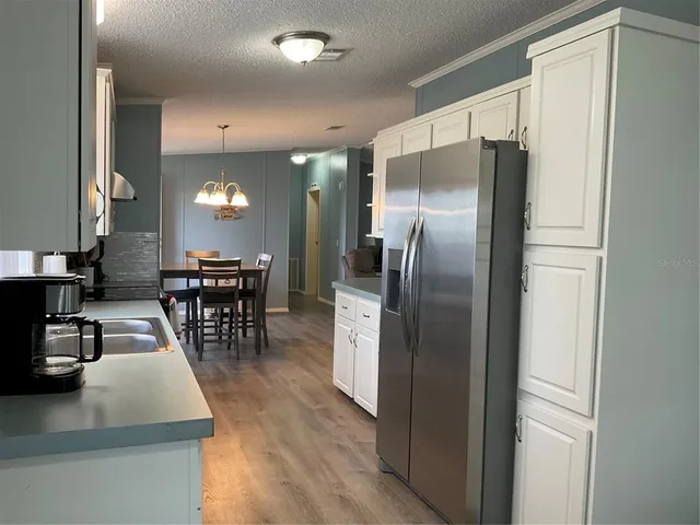 a bedroom with a bed and a flat tv screen on dresser