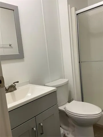 a kitchen with stainless steel appliances granite countertop a refrigerator a stove a sink dishwasher and microwave with wooden floor