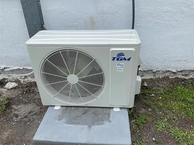 a view of a lake with a yard and large trees