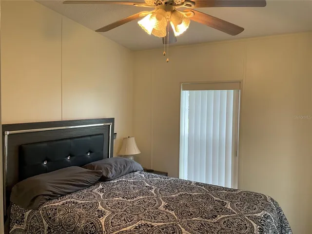 a view of a chandelier in big room and chandelier fan