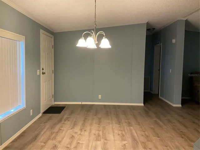 a view of a livingroom with furniture wooden floor and a ceiling fan