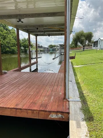 a view of a swimming pool with lawn chairs in the patio