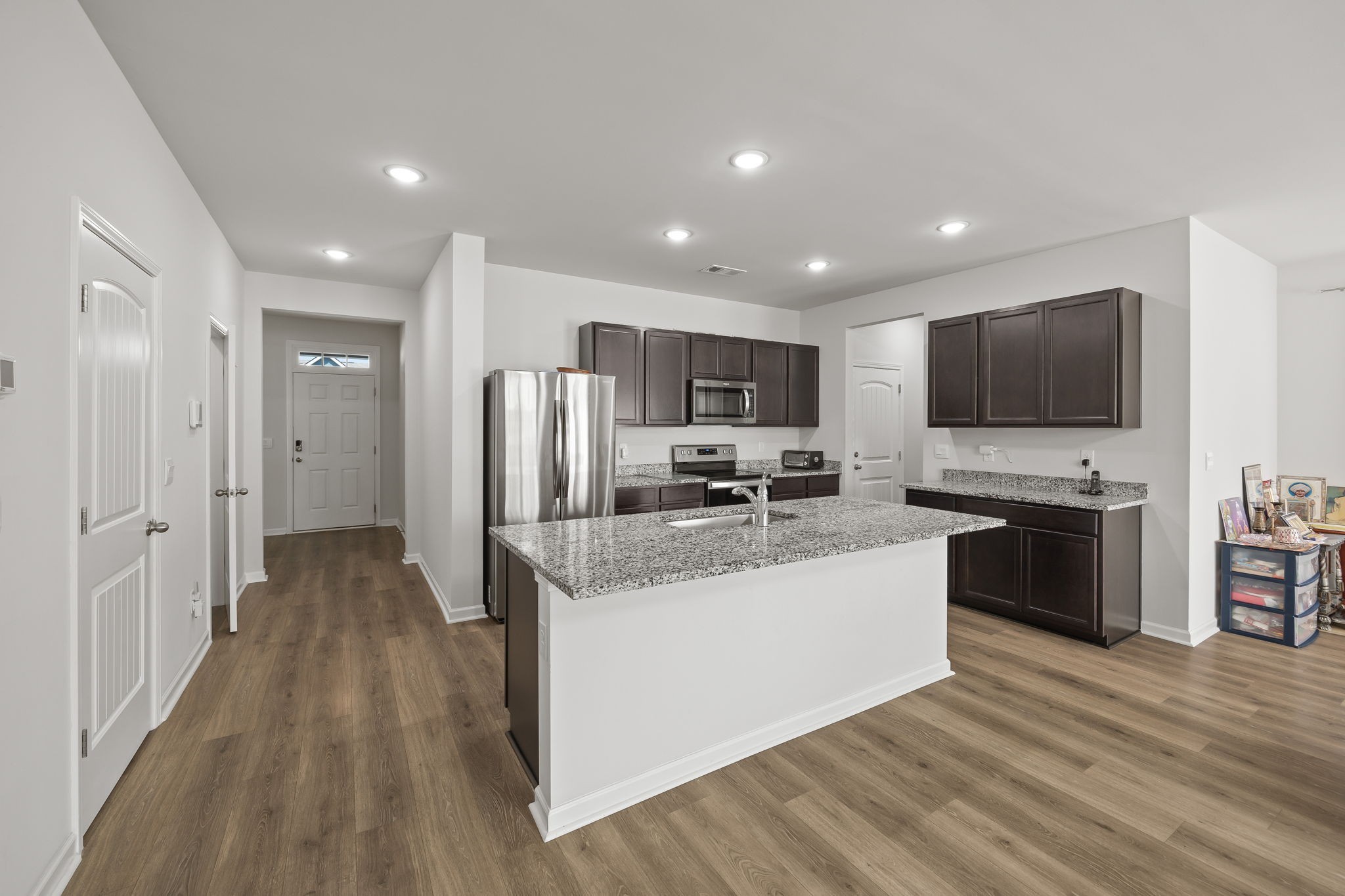 301 Oliver Way Baxter, TN 38544 - Photo 12 of 26 a kitchen with stainless steel appliances granite countertop a refrigerator stove a sink and dishwasher with wooden floor