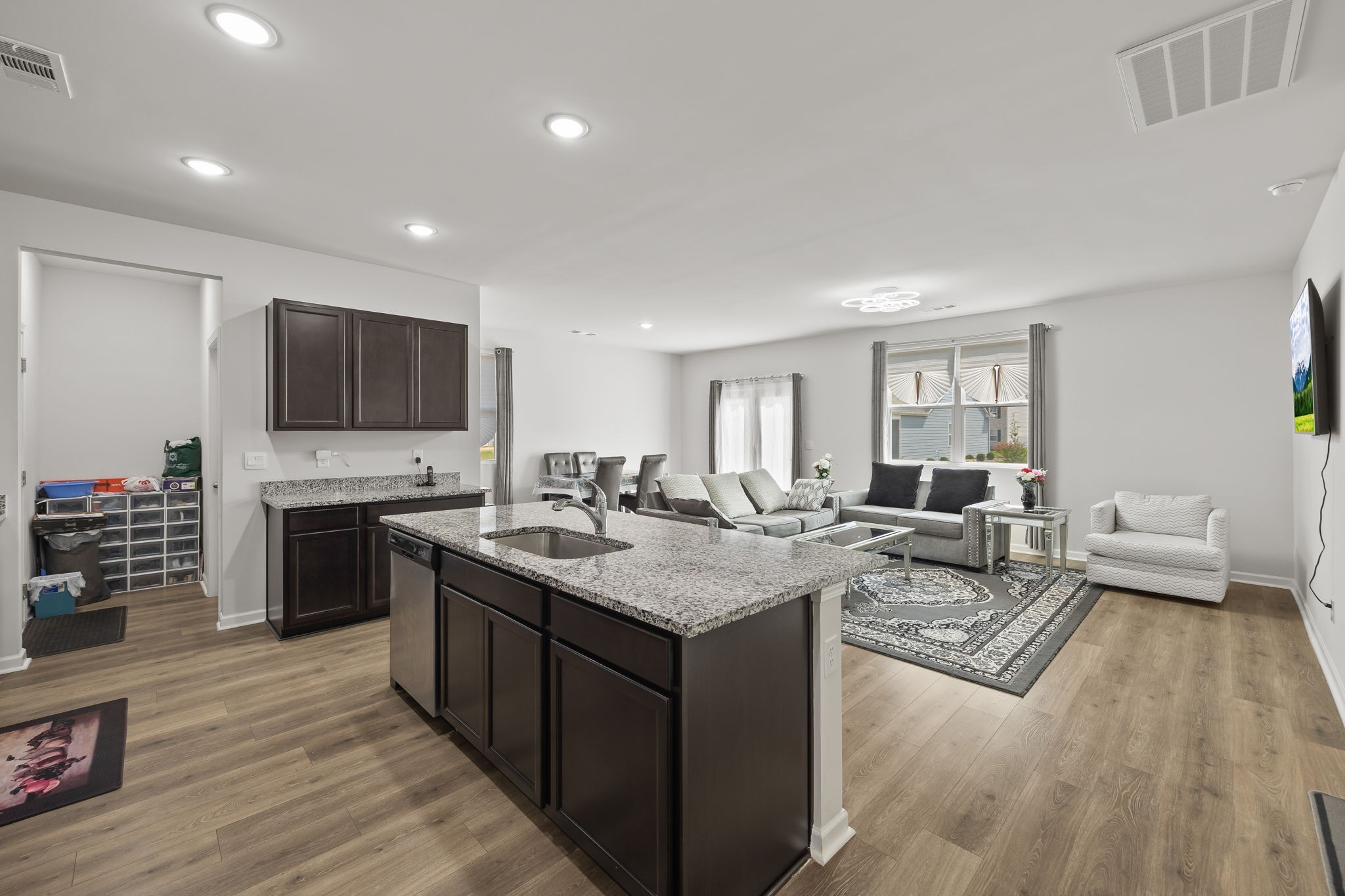 301 Oliver Way Baxter, TN 38544 - Photo 13 of 26 a open kitchen with stainless steel appliances granite countertop a stove top oven a sink dishwasher a dining table and chairs with wooden floor