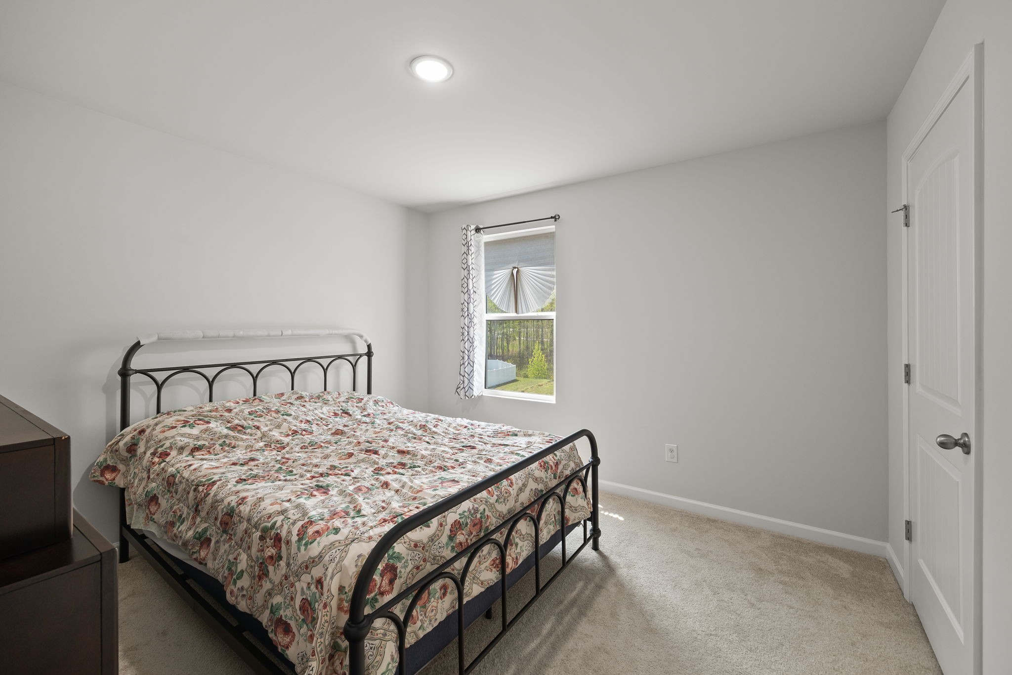 301 Oliver Way Baxter, TN 38544 - Photo 19 of 26 a bed sitting in a bedroom next to a window