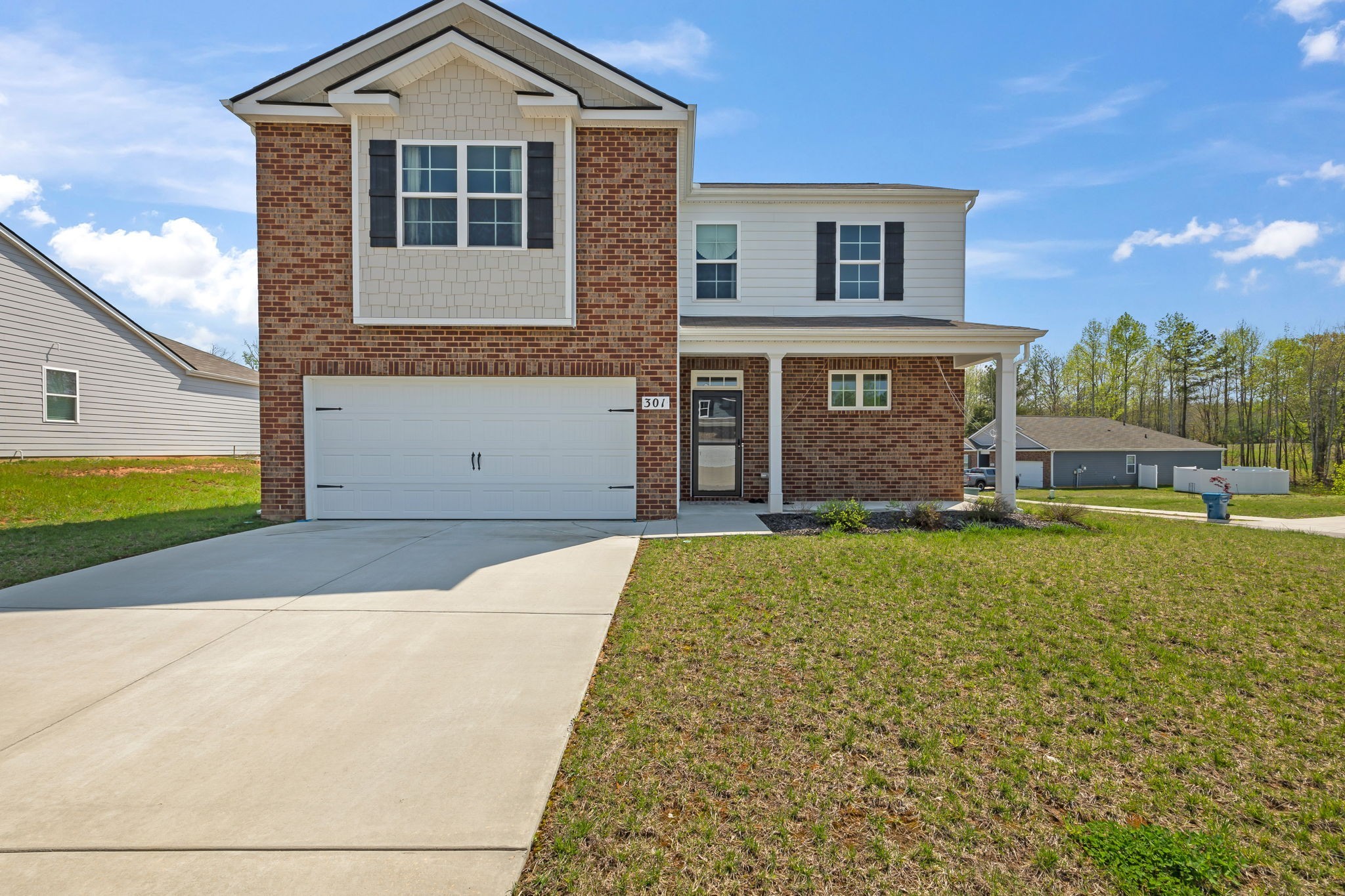 301 Oliver Way Baxter, TN 38544 - Photo 2 of 26 a front view of a house with a garden