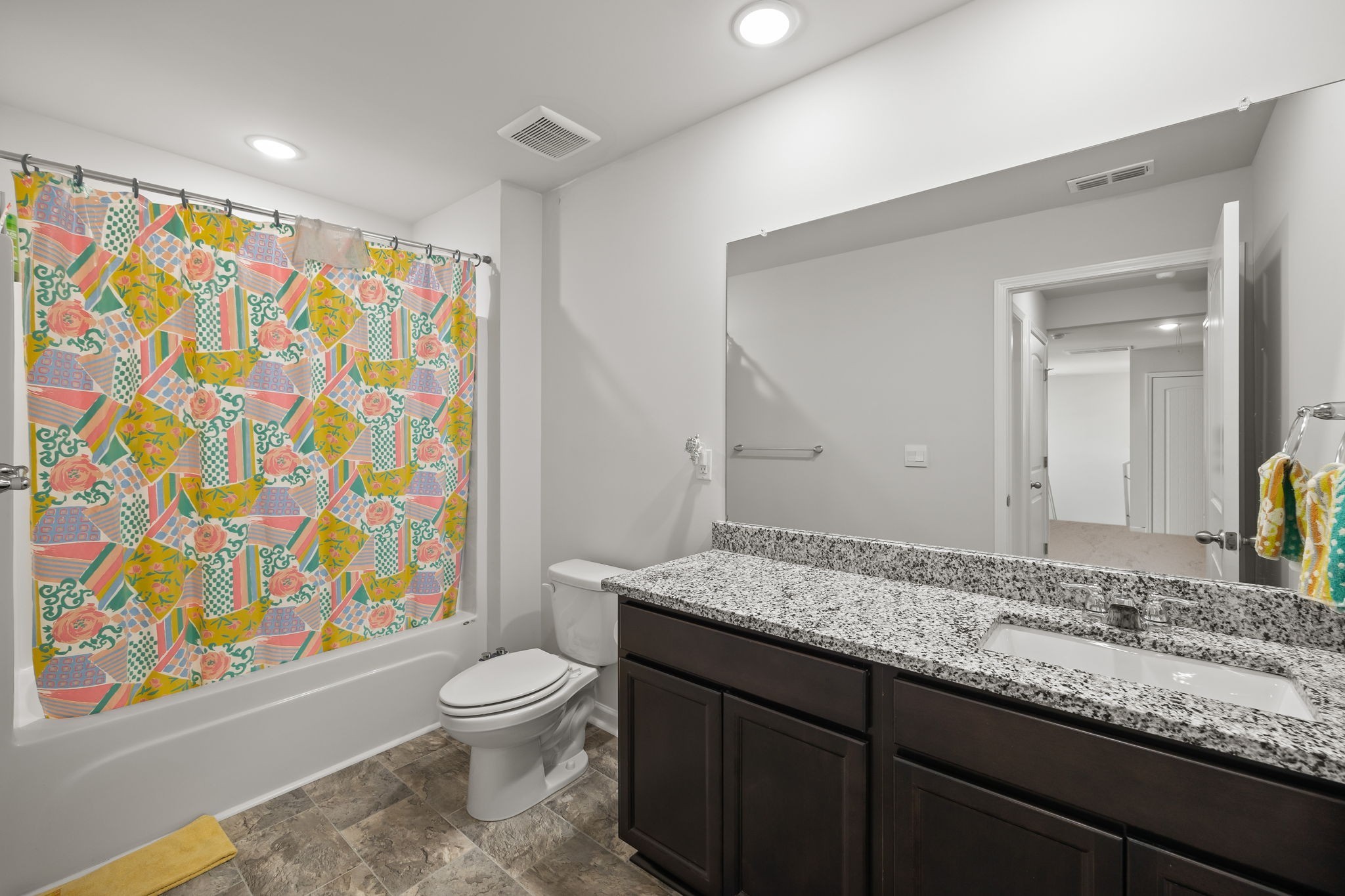 301 Oliver Way Baxter, TN 38544 - Photo 24 of 26 a bathroom with a granite countertop sink a toilet and a shower curtain