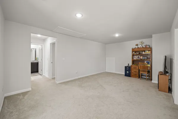 an empty room with furniture and a large window