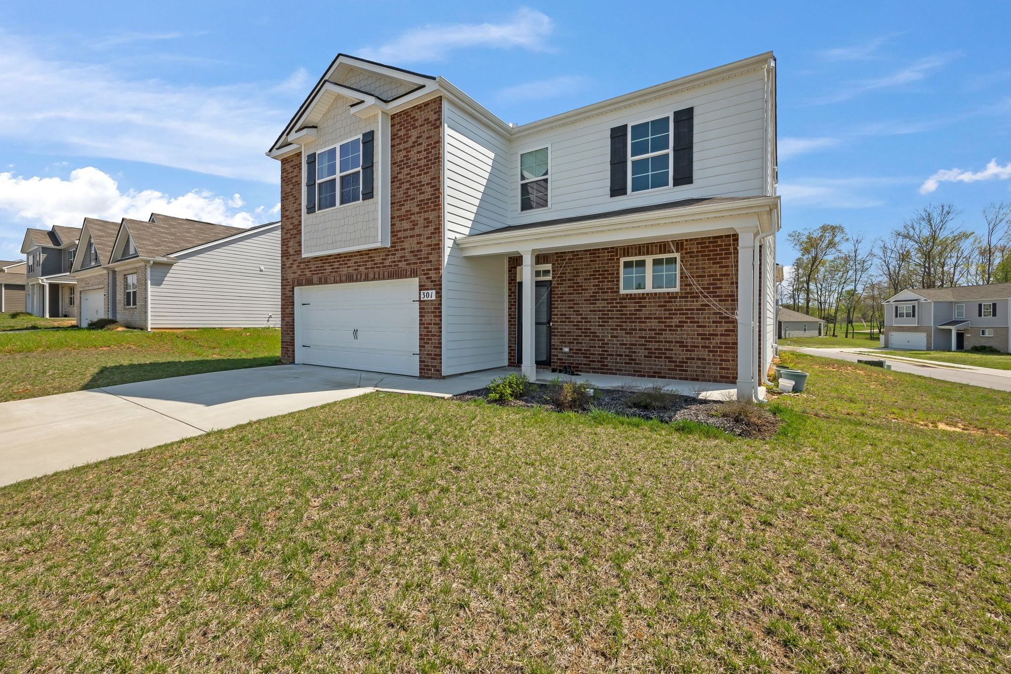 301 Oliver Way Baxter, TN 38544 - Photo 3 of 26 a front view of a house with garden