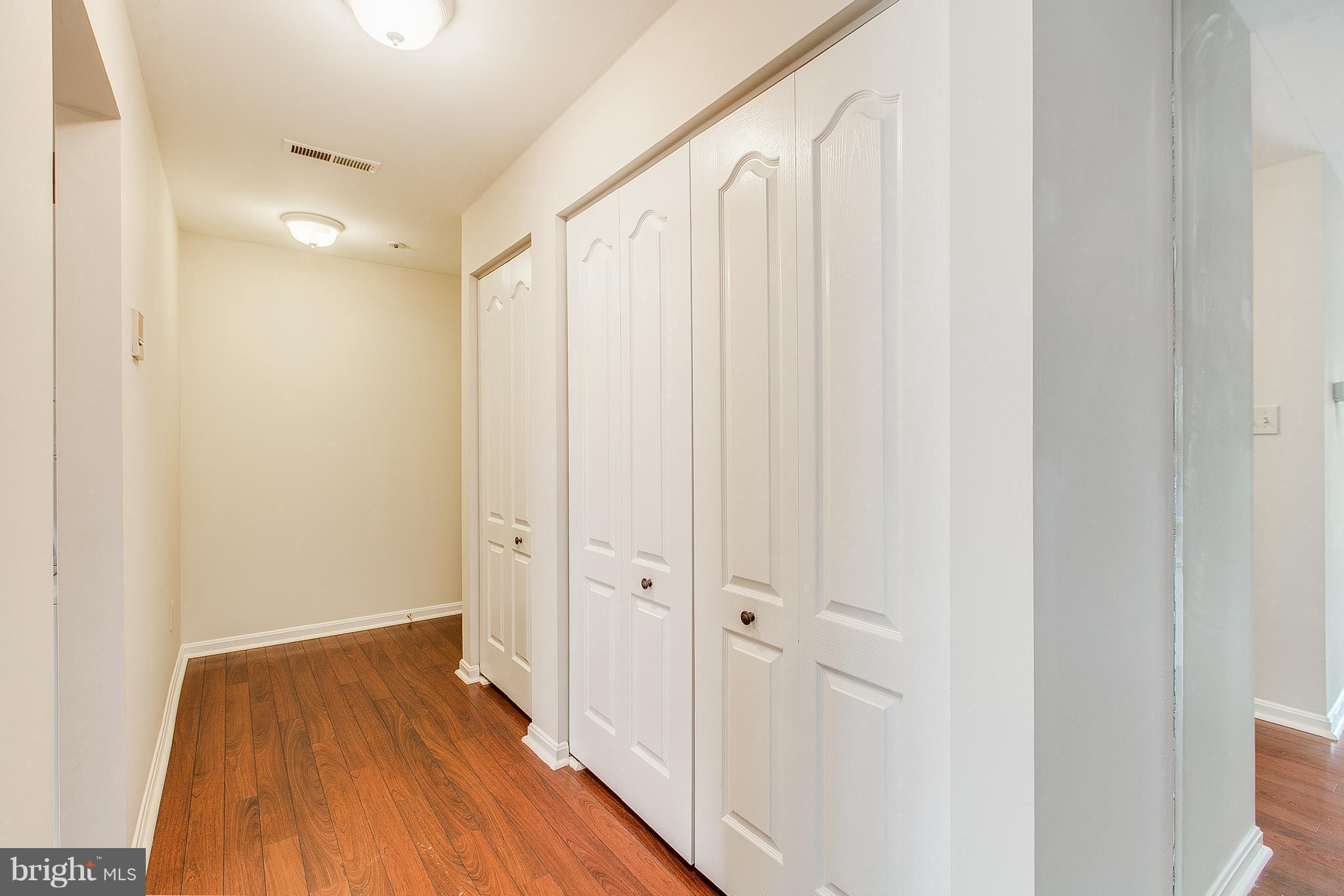 8601 Falls Run Road, Unit F Ellicott City, MD 21043 - Photo 16 of 17 a view of a hallway with wooden floor