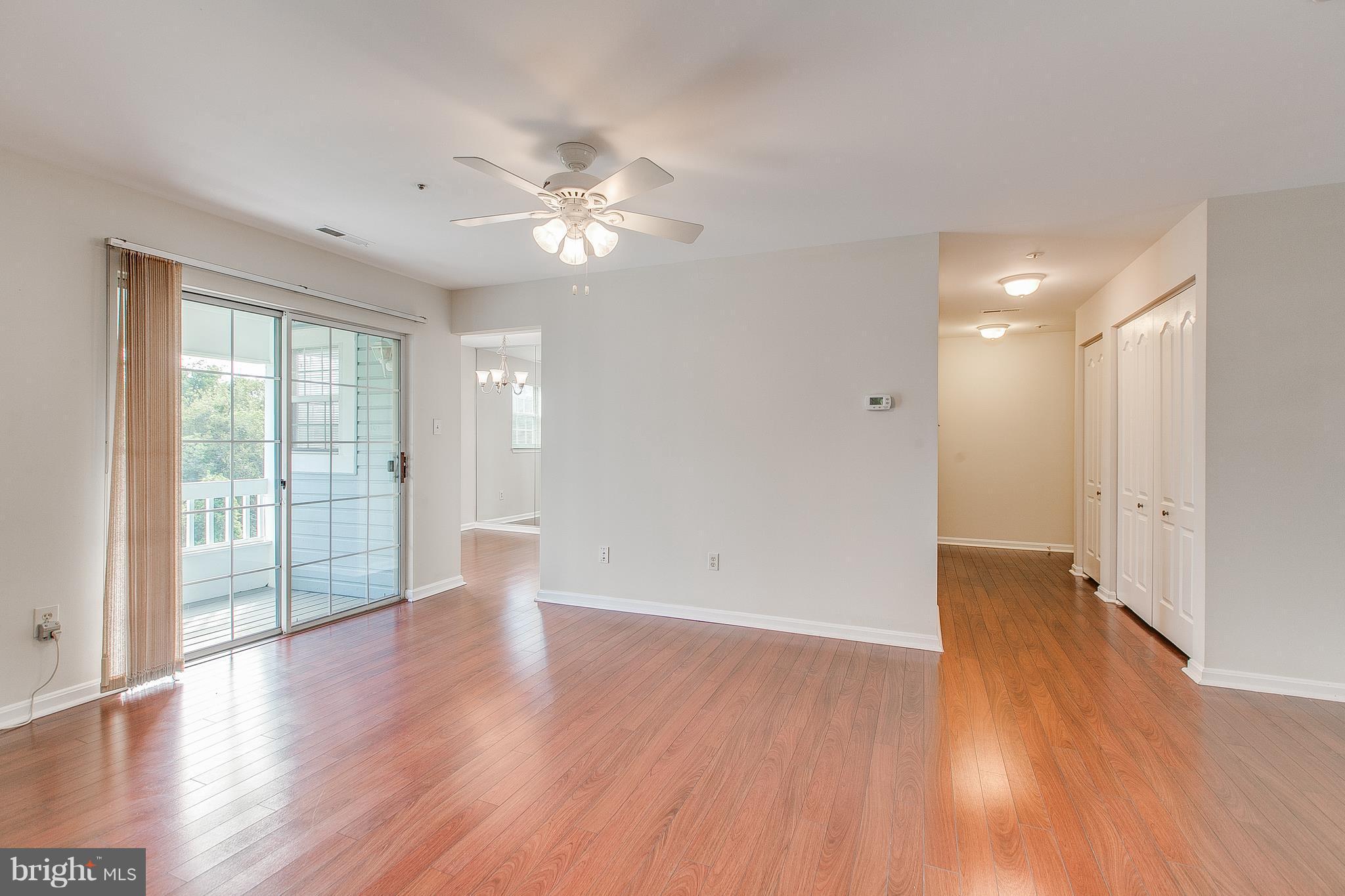 8601 Falls Run Road, Unit F Ellicott City, MD 21043 - Photo 3 of 17 a view of an empty room with wooden floor and a window