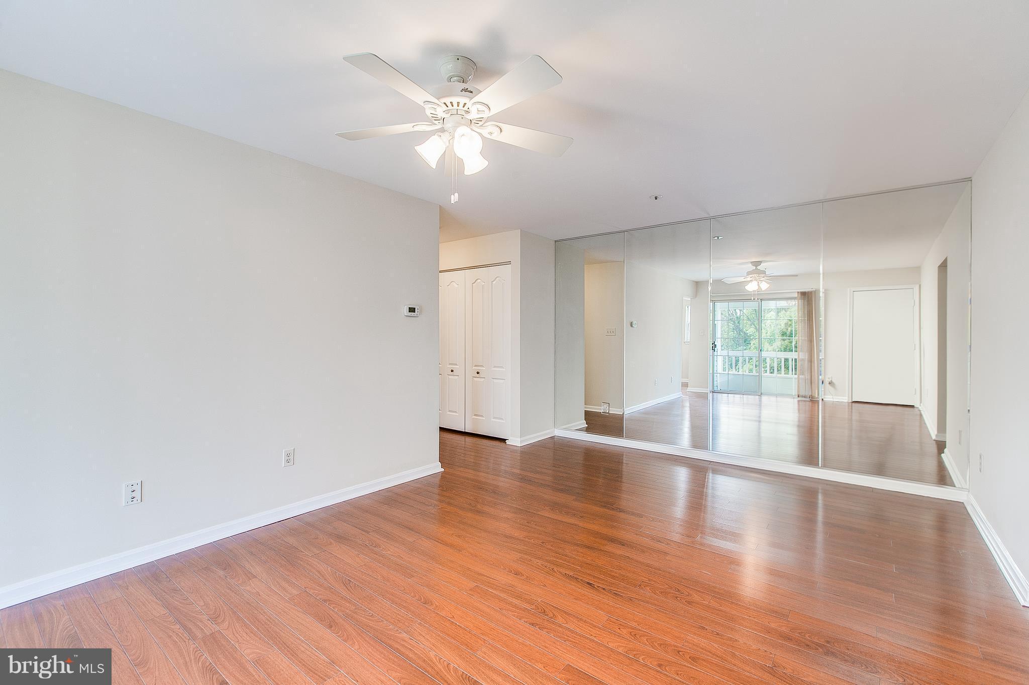 8601 Falls Run Road, Unit F Ellicott City, MD 21043 - Photo 4 of 17 wooden floor in an empty room with a window