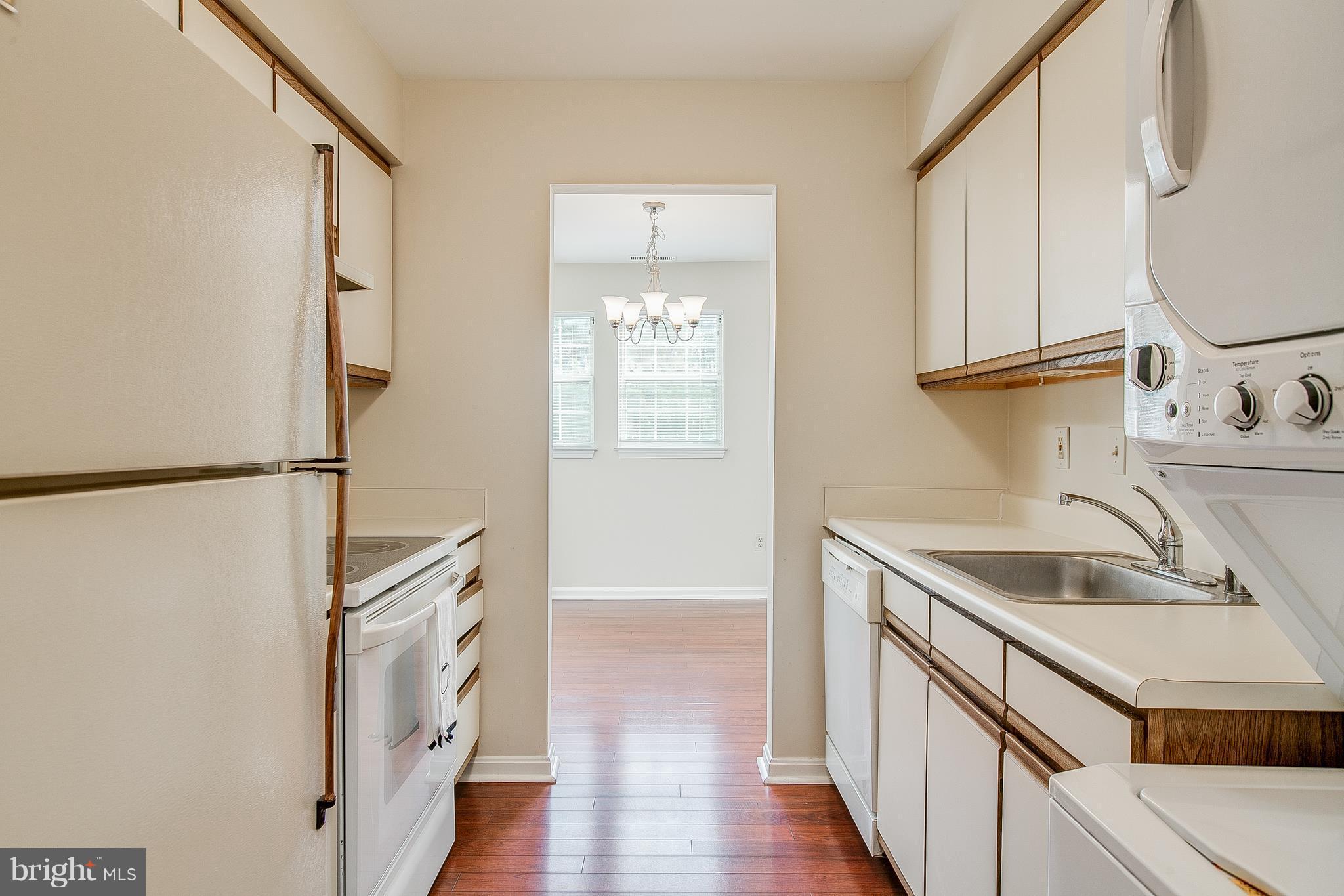 8601 Falls Run Road, Unit F Ellicott City, MD 21043 - Photo 6 of 17 a kitchen with stainless steel appliances granite countertop a sink and a refrigerator