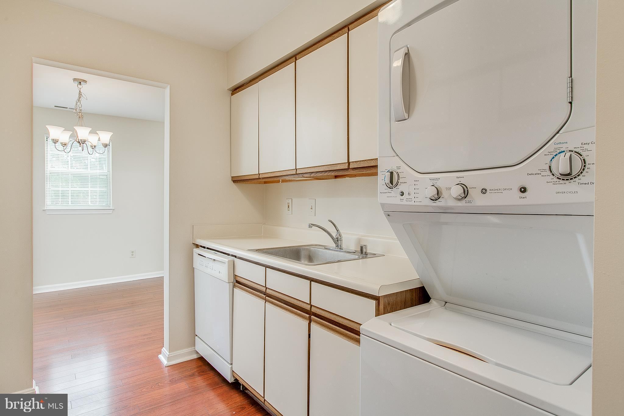 8601 Falls Run Road, Unit F Ellicott City, MD 21043 - Photo 7 of 17 a utility room with cabinets washer and dryer