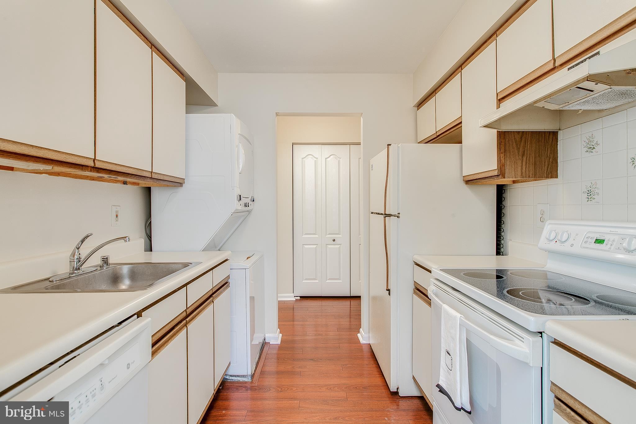8601 Falls Run Road, Unit F Ellicott City, MD 21043 - Photo 8 of 17 a kitchen with a sink and a refrigerator