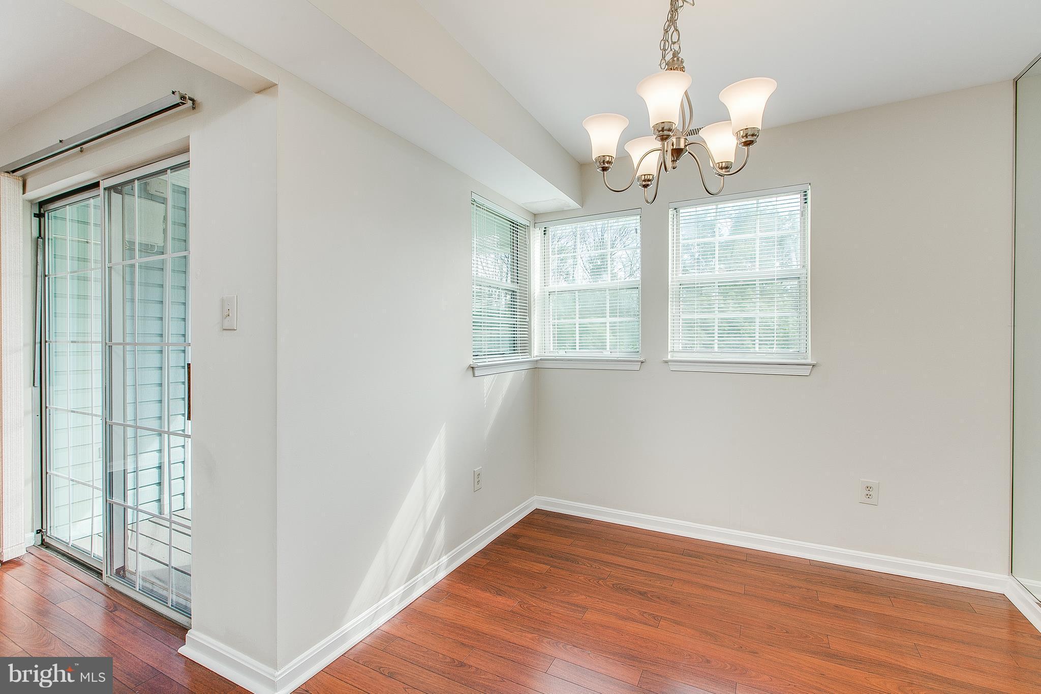 8601 Falls Run Road, Unit F Ellicott City, MD 21043 - Photo 9 of 17 wooden floor in an empty room with a window