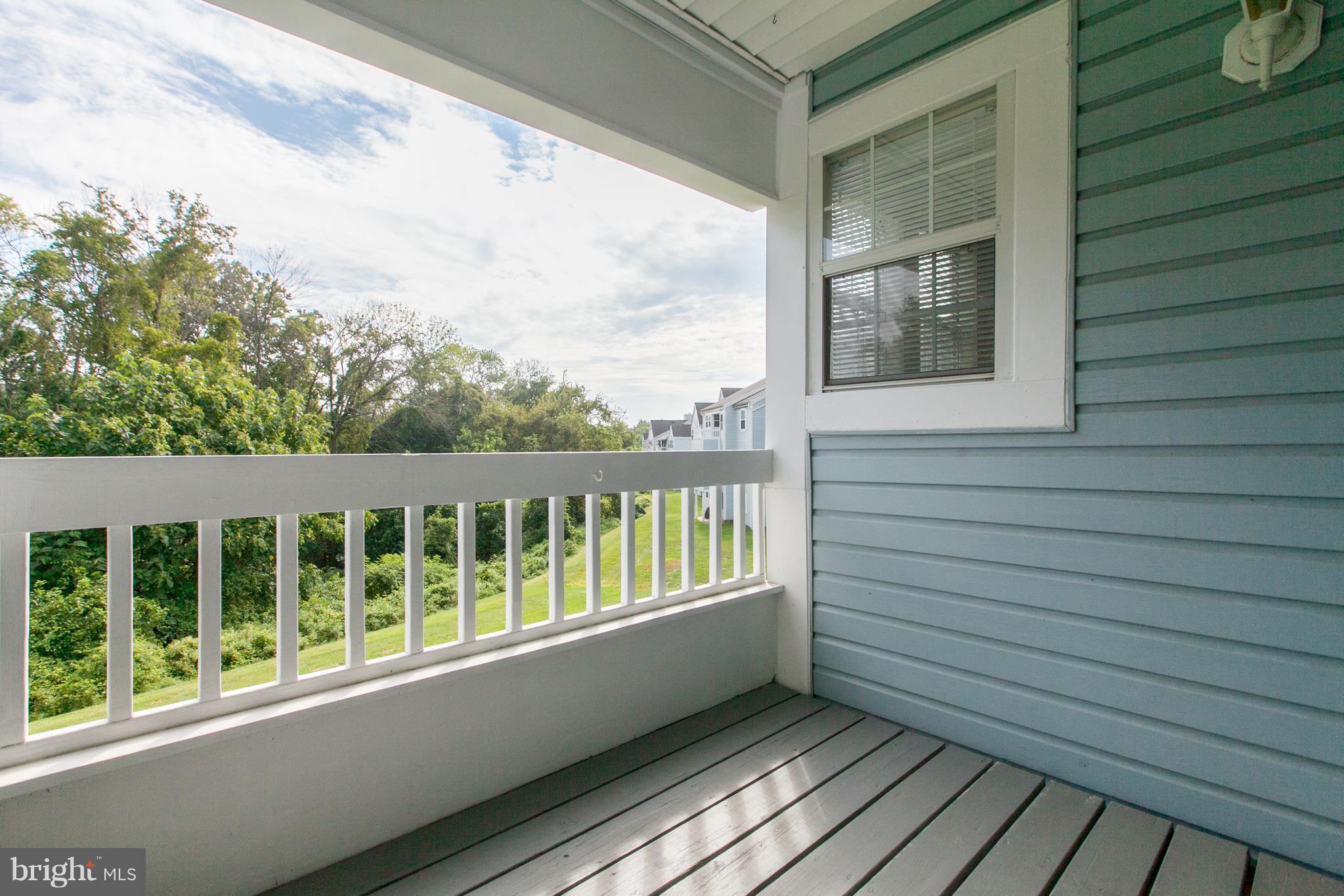 8601 Falls Run Road, Unit F Ellicott City, MD 21043 - Photo 10 of 17 a view of a balcony with wooden floor