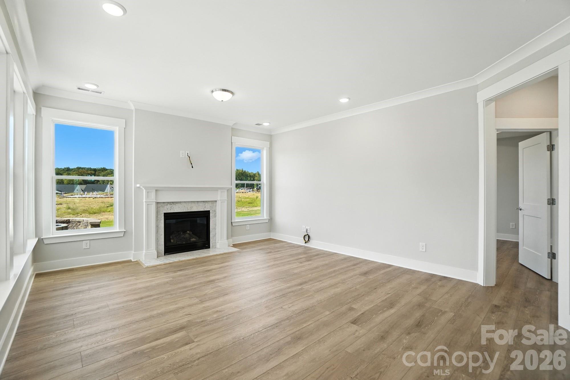2007 Mantle Rdg Drive Indian Trail, NC 28079 - Photo 13 of 48 a view of empty room with wooden floor and fireplace