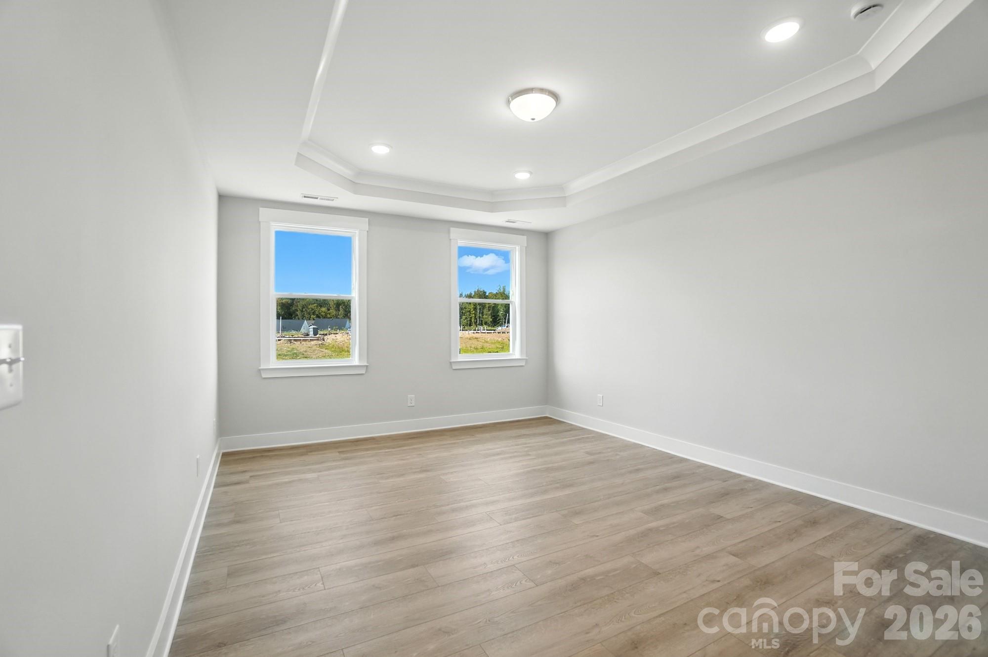 2007 Mantle Rdg Drive Indian Trail, NC 28079 - Photo 20 of 48 an empty room with wooden floor and windows