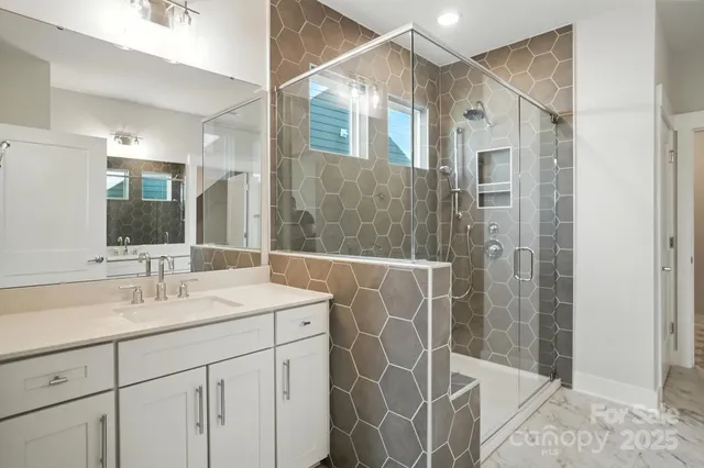 a spacious bathroom with a granite countertop sink a toilet and a mirror