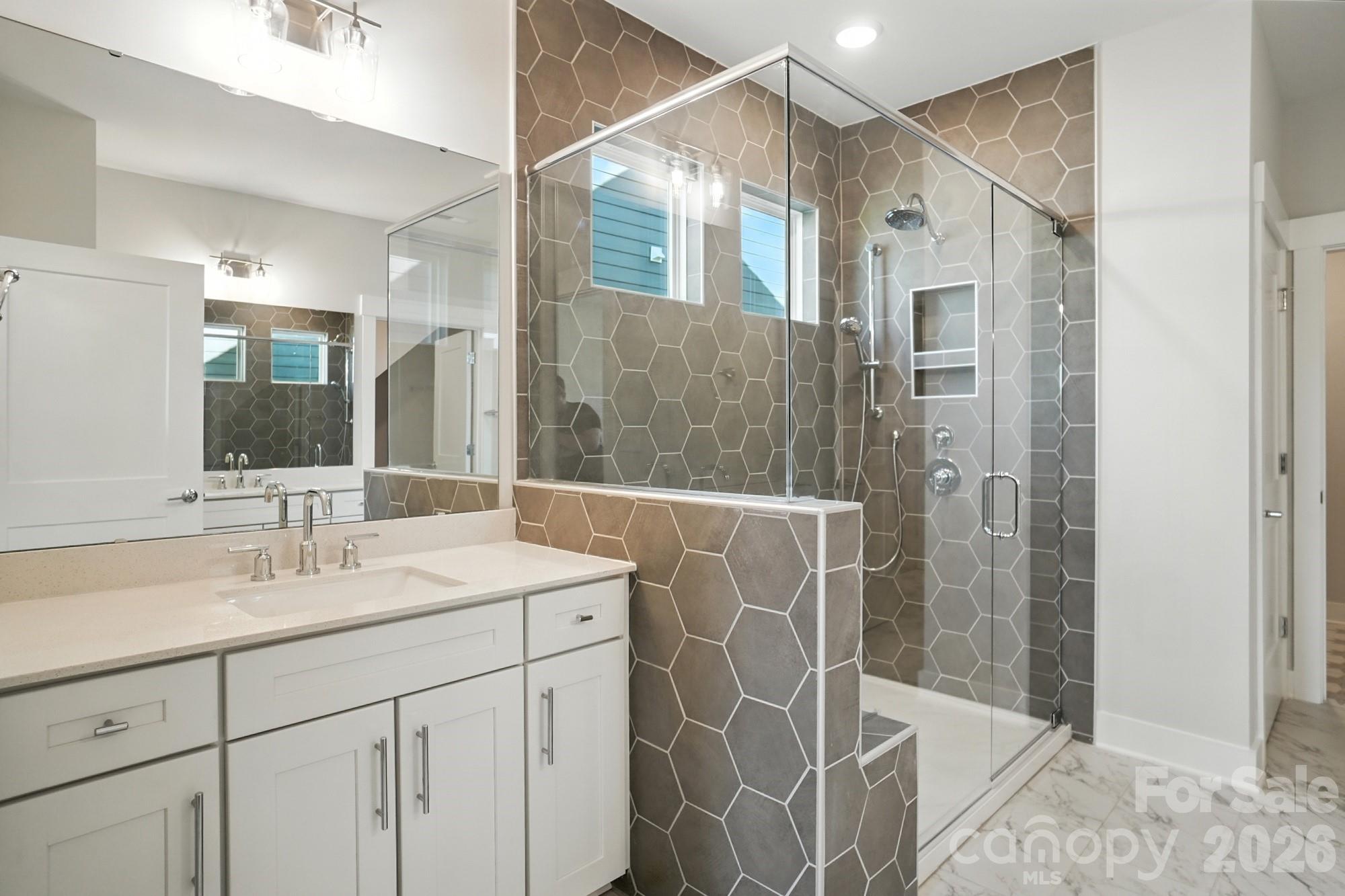 2007 Mantle Rdg Drive Indian Trail, NC 28079 - Photo 22 of 48 a bathroom with a shower sink and mirror