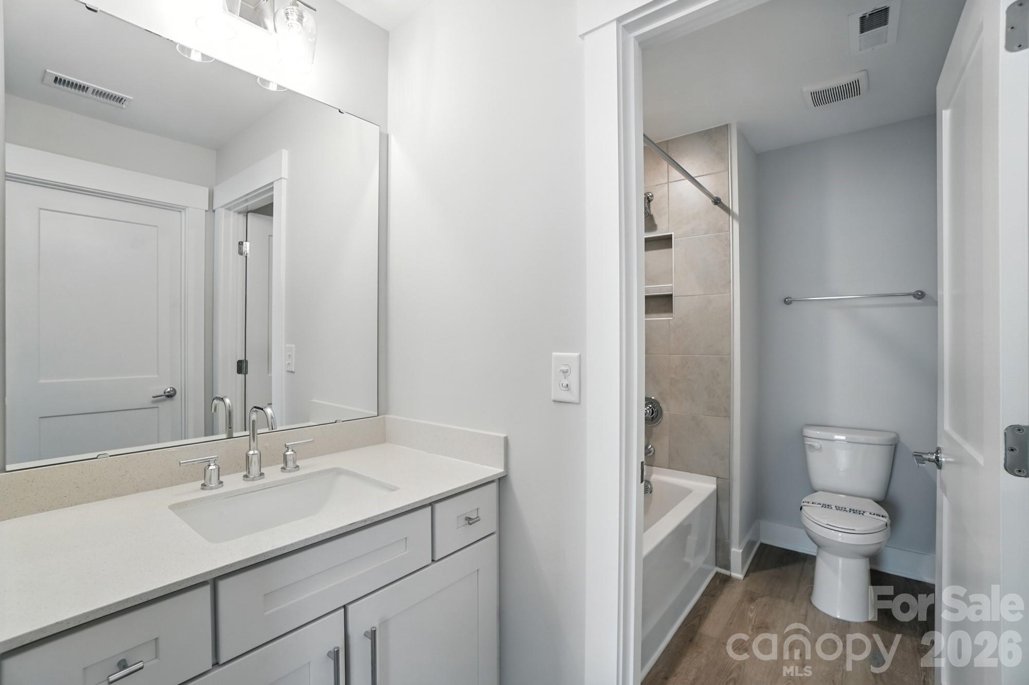 2007 Mantle Rdg Drive Indian Trail, NC 28079 - Photo 30 of 48 a bathroom with a sink toilet a shower and a mirror