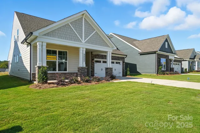a view of a house with a yard patio and swimming pool