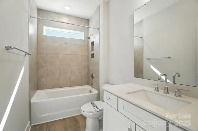 a bathroom with a bath tub sink mirror and a shower