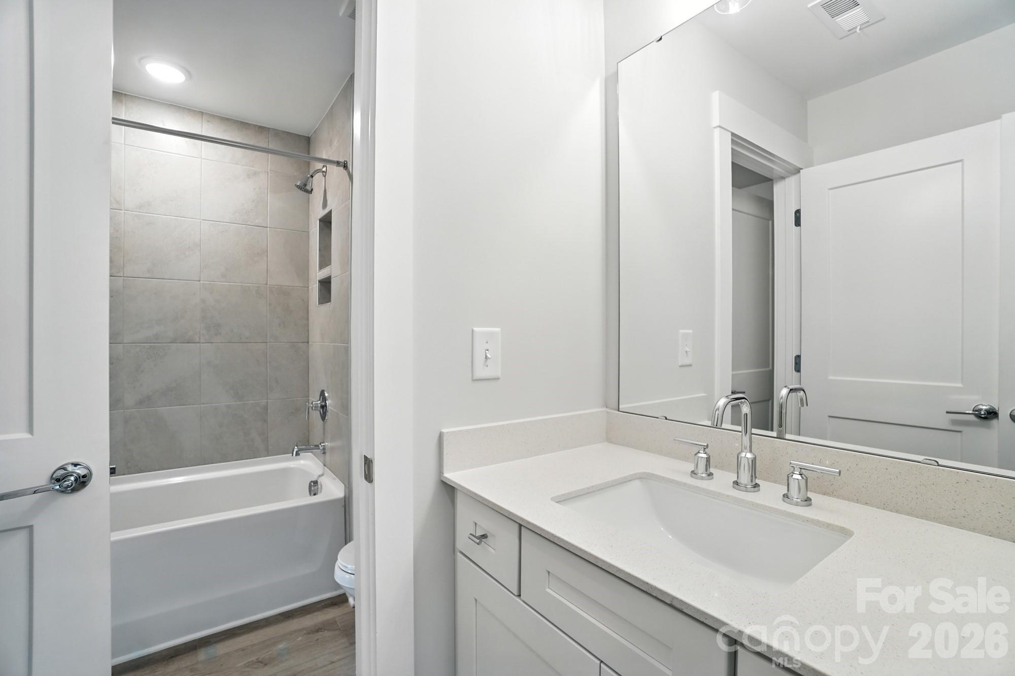 2007 Mantle Rdg Drive Indian Trail, NC 28079 - Photo 32 of 48 a bathroom with a bathtub shower sink vanity and a mirror