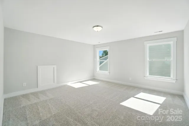 an empty room with a kitchen