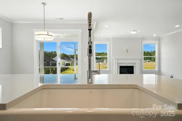 a kitchen with a sink and chandelier