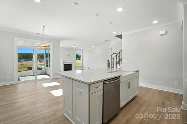 a kitchen with stainless steel appliances a sink stove and cabinets
