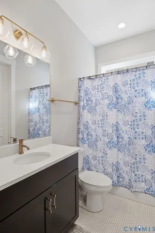 a bathroom with a sink a toilet and mirror