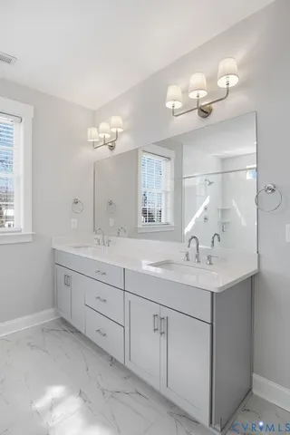 a bathroom with a sink a light fixture and a light fixture
