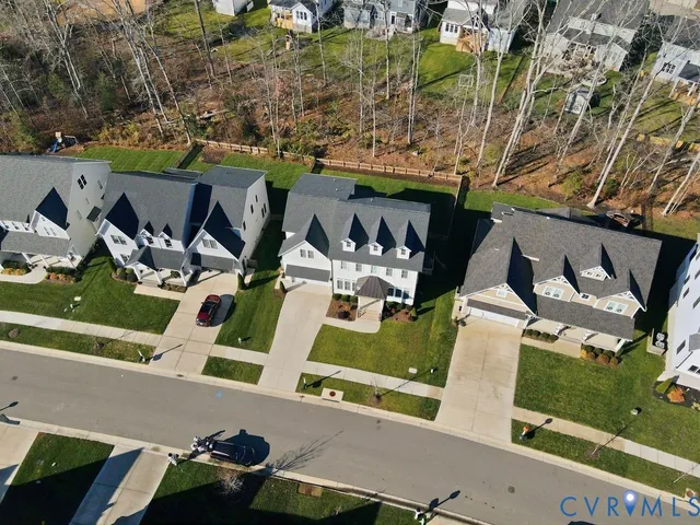 an aerial view of a house with a yard and seating area