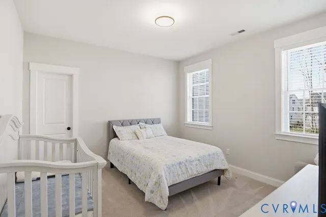 a bedroom with a bed a window and closet